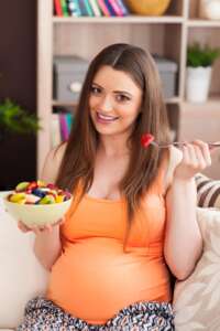 Pregnant woman doing prenatal yoga to support gentle birth.