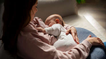 newborn breastfeeding close up showing natural bonding